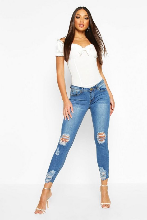 Mid Rise Distressed Knee And Ankle Skinny Jeans